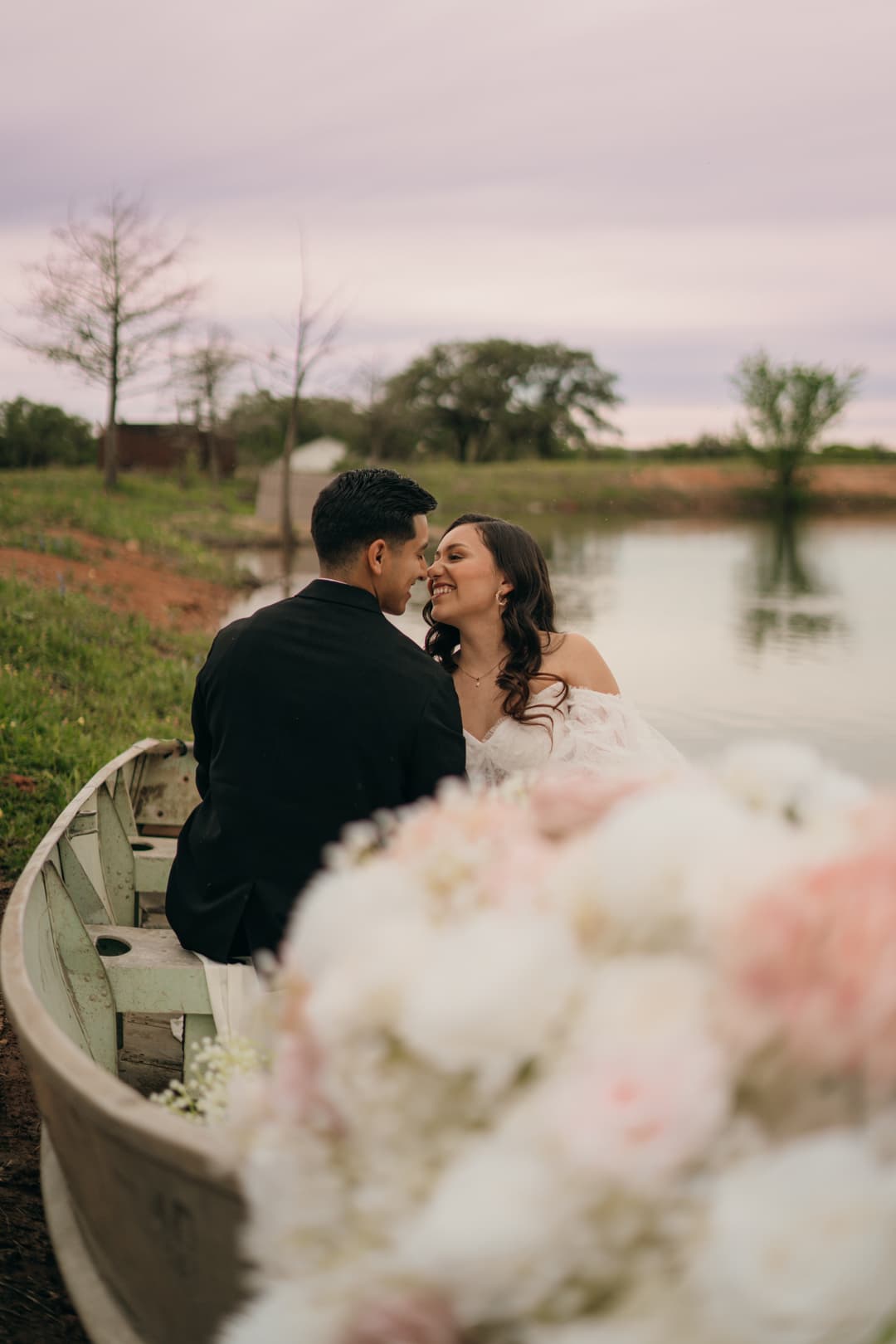 Bride & Groom posing in boat